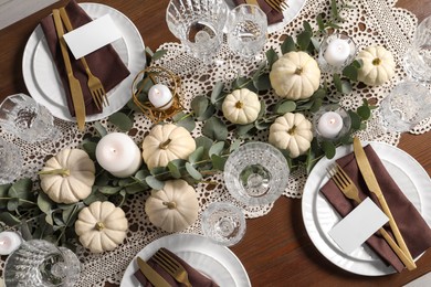 Photo of Beautiful autumn table setting. Plates, cutlery, glasses, blank cards and floral decor, flat lay