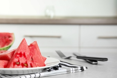 Photo of Yummy cut watermelon on table in kitchen, closeup. Space for text