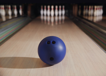Photo of Blue ball on bowling lane in club