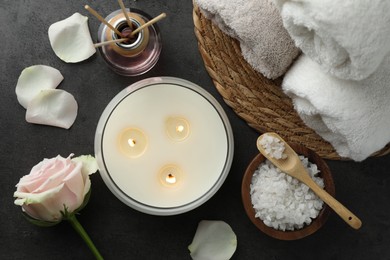 Flat lay composition with different spa products and rose flower on grey table