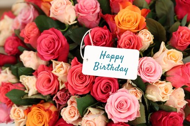 Image of Bouquet of beautiful roses with Happy Birthday card, top view