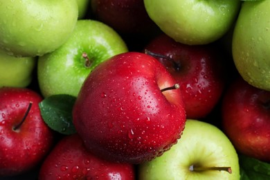 Photo of Fresh ripe green and red apples with water drops as background, top view
