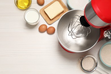 Photo of Modern red stand mixer and different ingredients on white wooden table, flat lay. Space for text