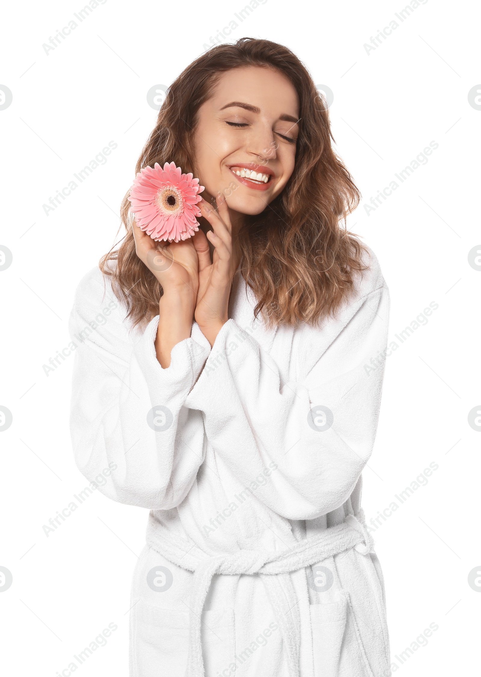 Photo of Beautiful young woman with flower wearing bathrobe on white background