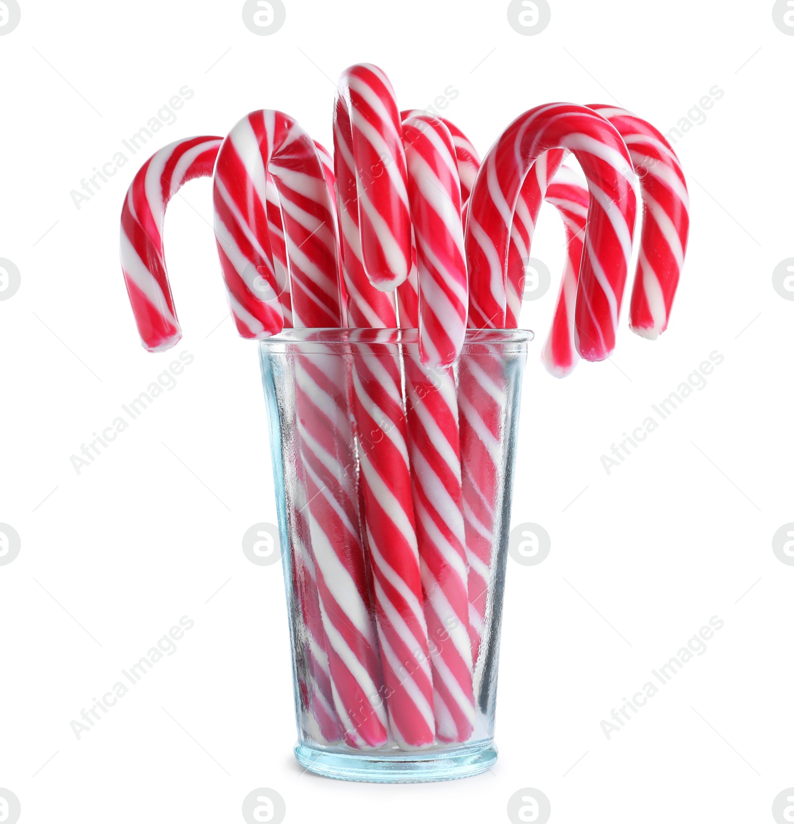 Photo of Glass with sweet Christmas candy canes on white background