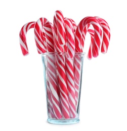 Photo of Glass with sweet Christmas candy canes on white background