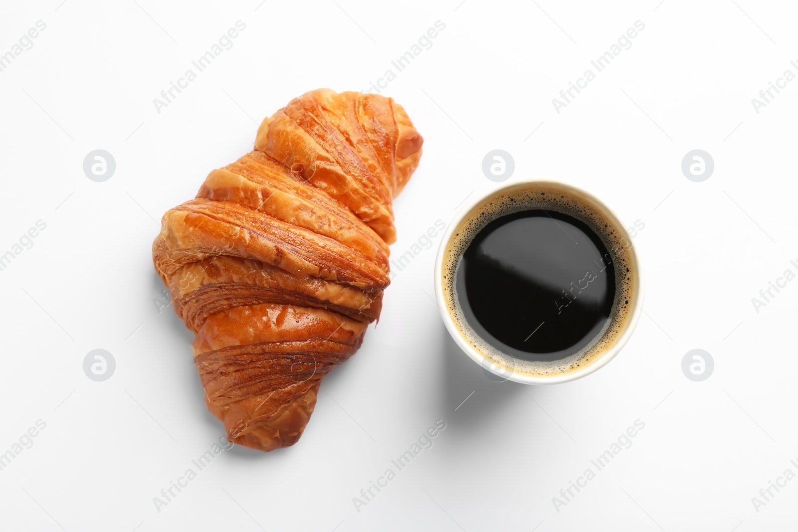 Photo of Delicious fresh croissant and paper cup of coffee on white background, flat lay