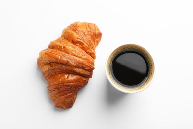 Delicious fresh croissant and paper cup of coffee on white background, flat lay