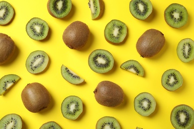 Top view of fresh kiwis on yellow background