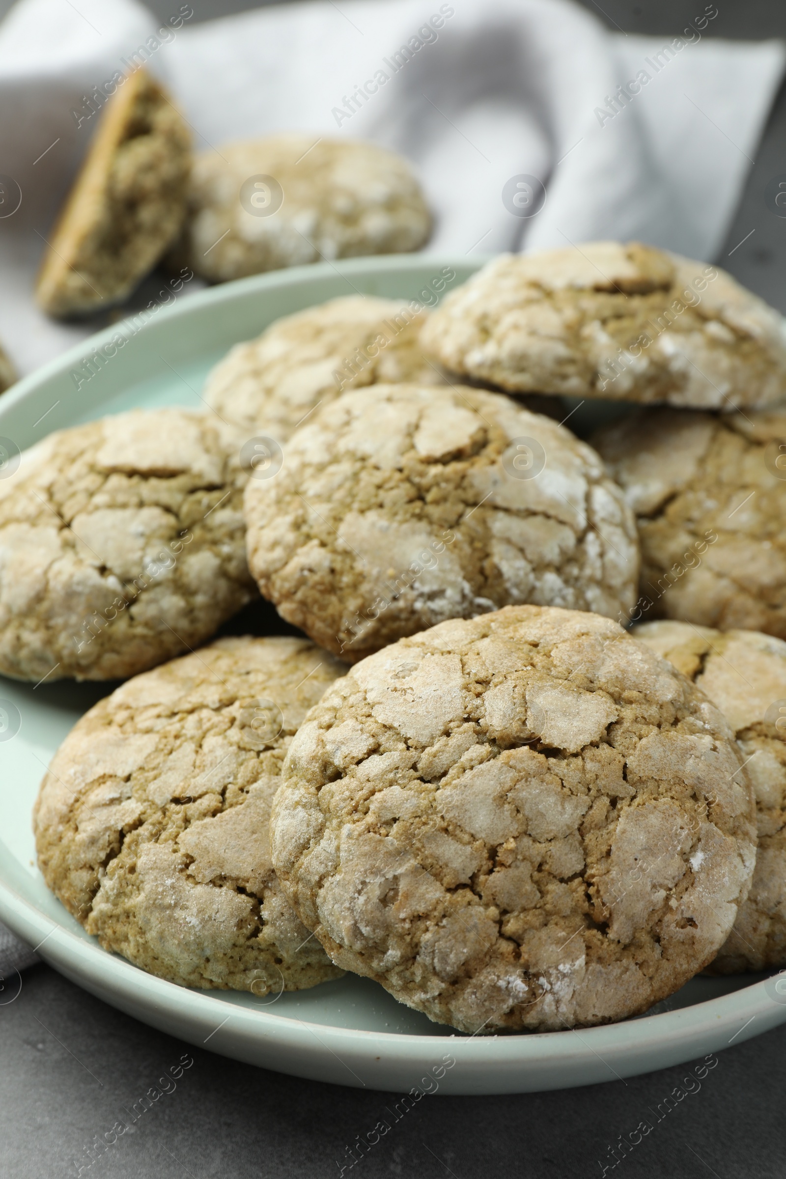 Photo of Plate with tasty matcha cookies on grey table, closeup