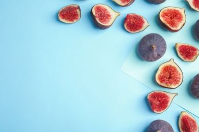 Delicious ripe figs on color background, flat lay. Space for text