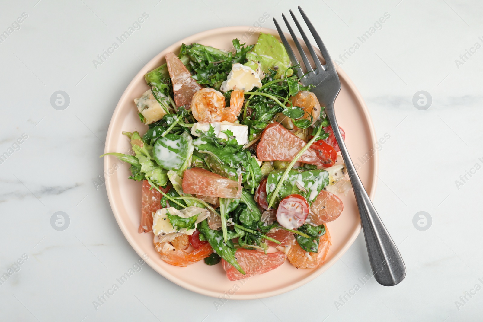 Photo of Delicious pomelo salad with shrimps served on white table, top view