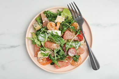 Delicious pomelo salad with shrimps served on white table, top view