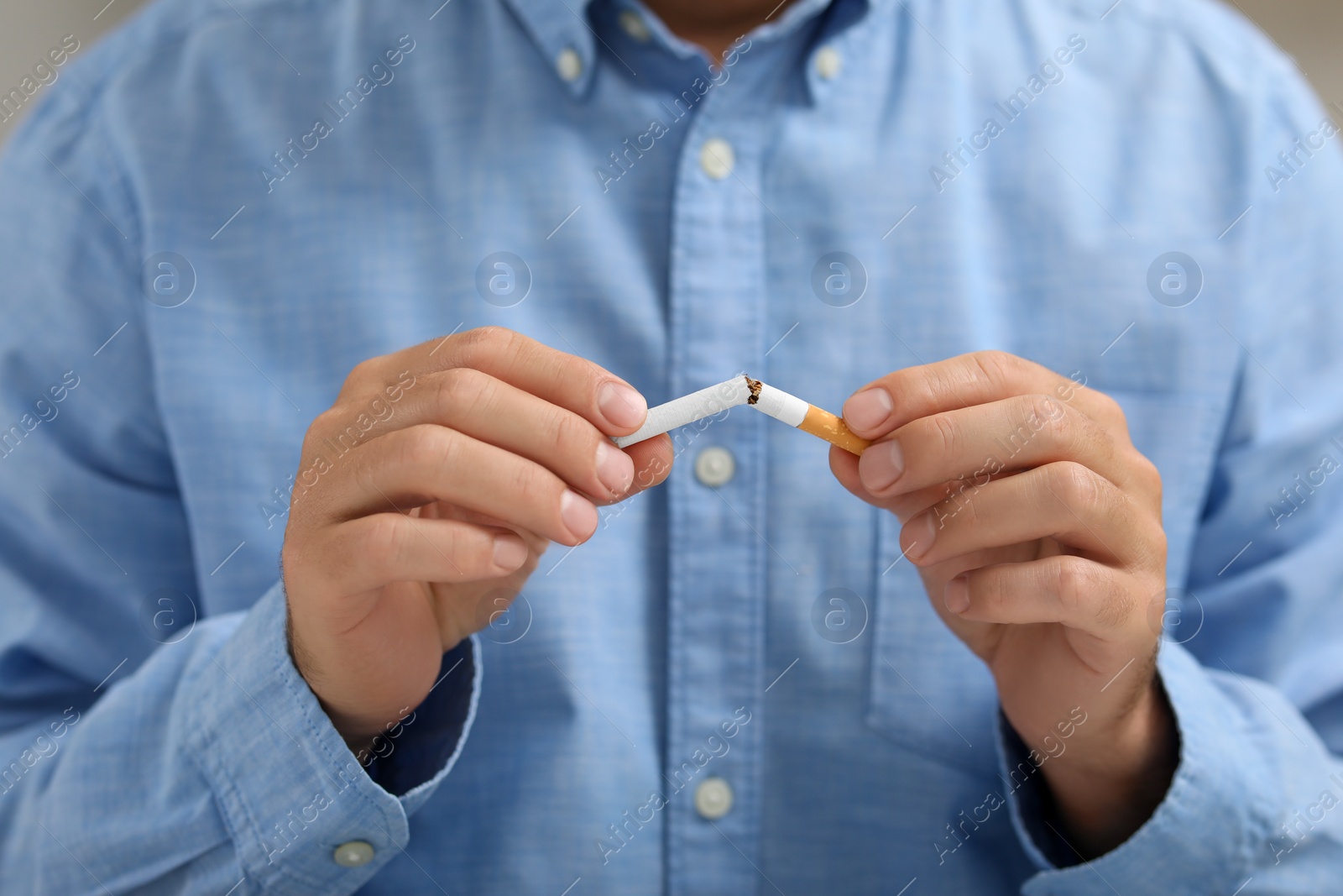 Photo of Stop smoking concept. Man breaking cigarette, closeup