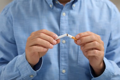 Photo of Stop smoking concept. Man breaking cigarette, closeup