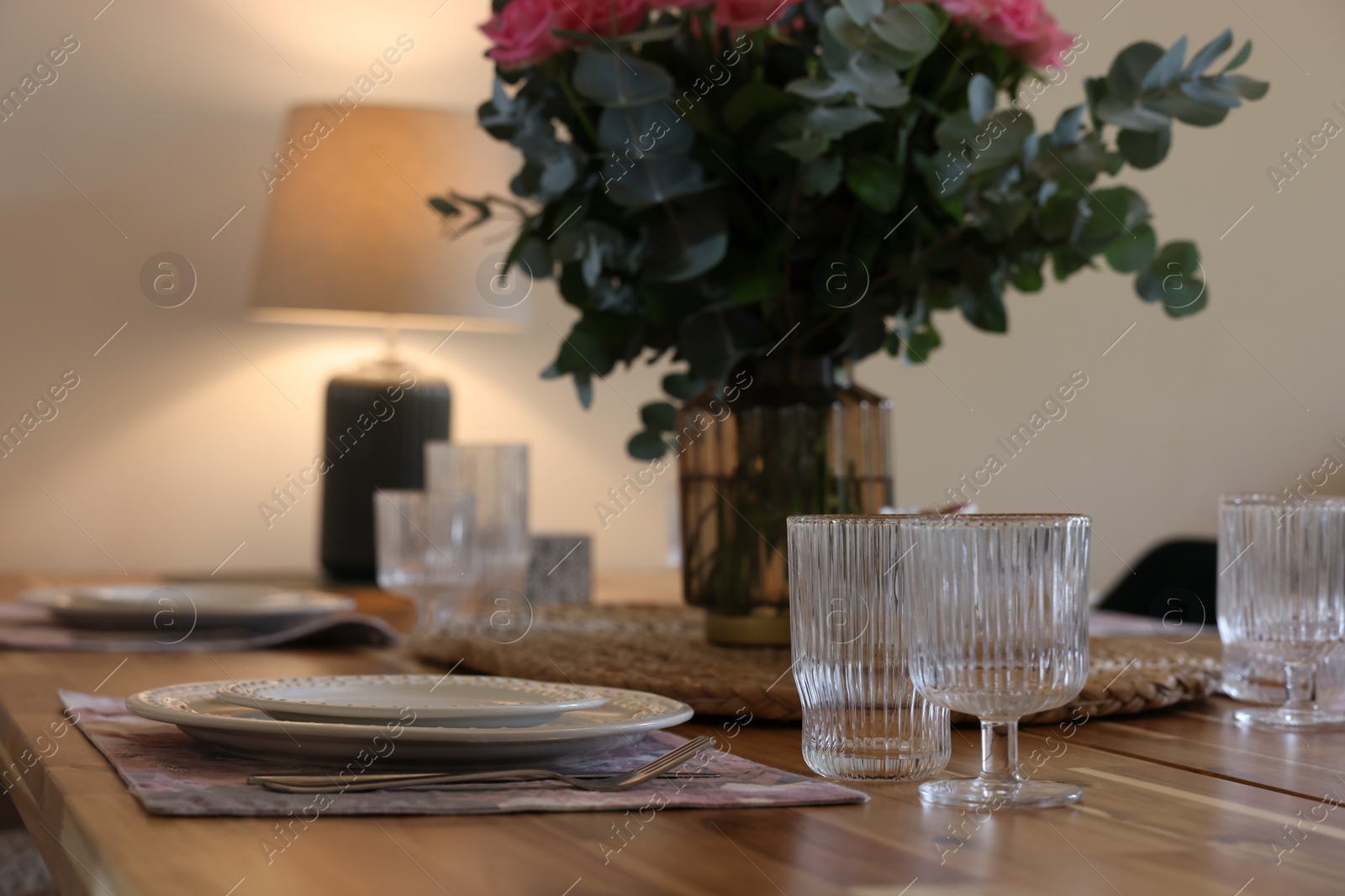 Photo of Beautiful table setting. Plates, cutlery, glasses and napkin indoors