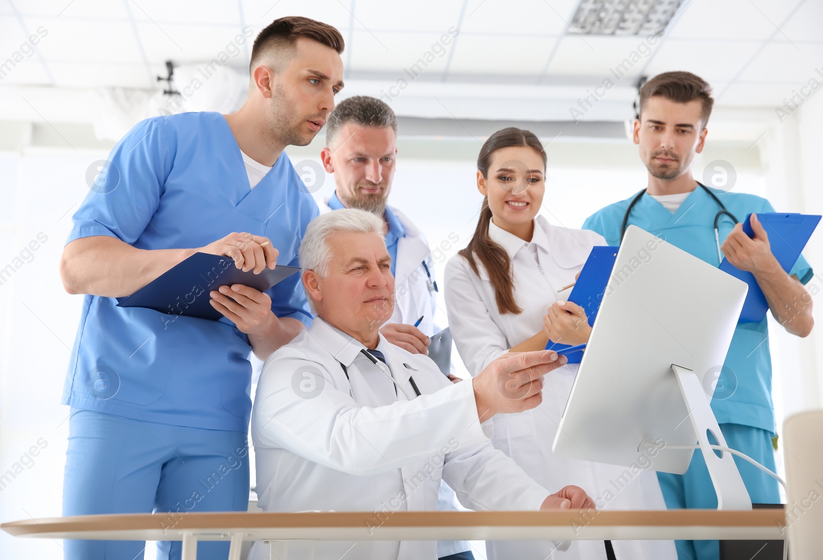 Photo of Group of doctors attending meeting in clinic. Cardiology conference