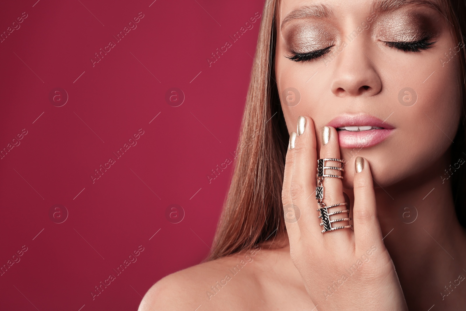 Photo of Beautiful woman with stylish nail polish on color background, space for text