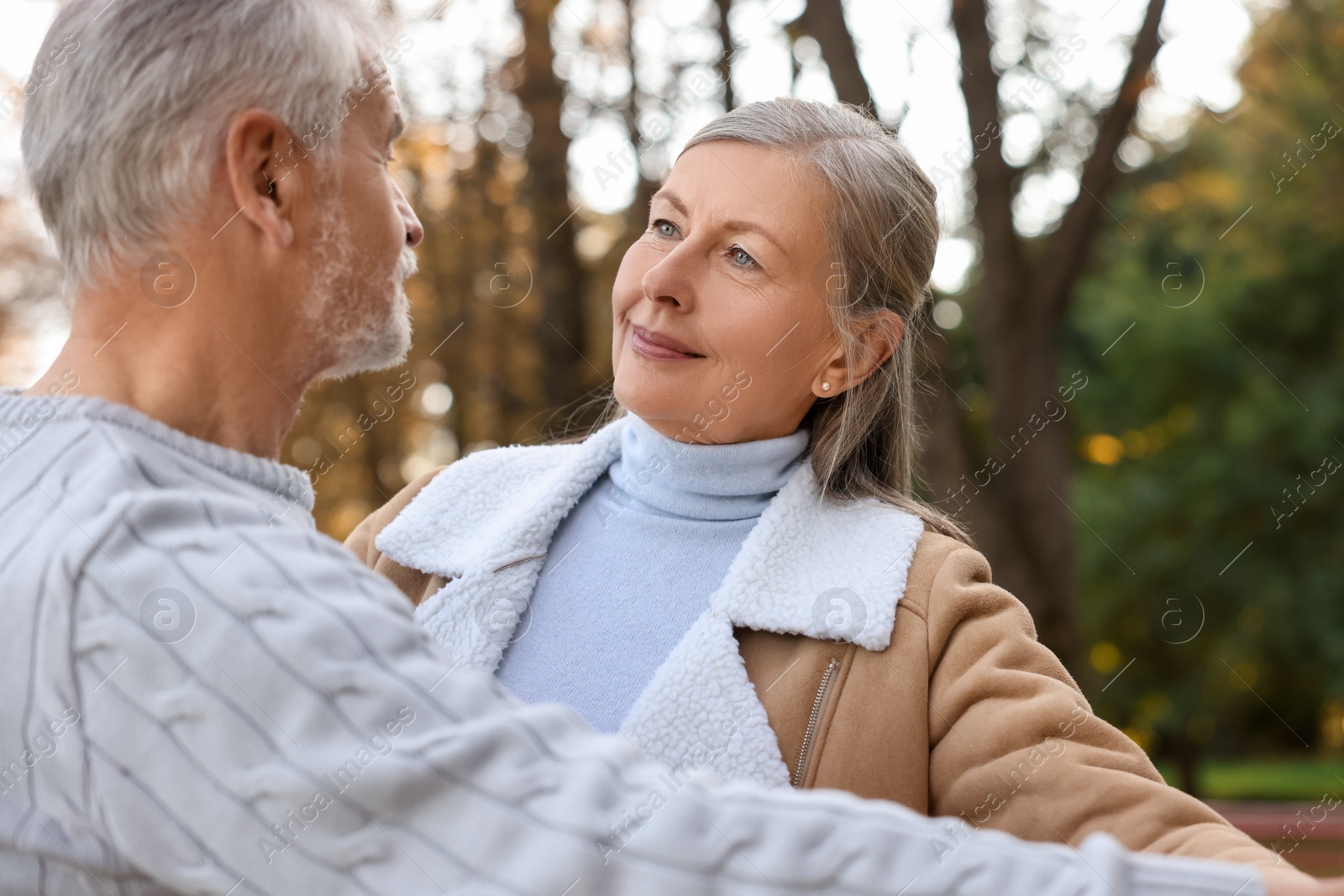 Photo of Affectionate senior couple dancing together outdoors. Romantic date