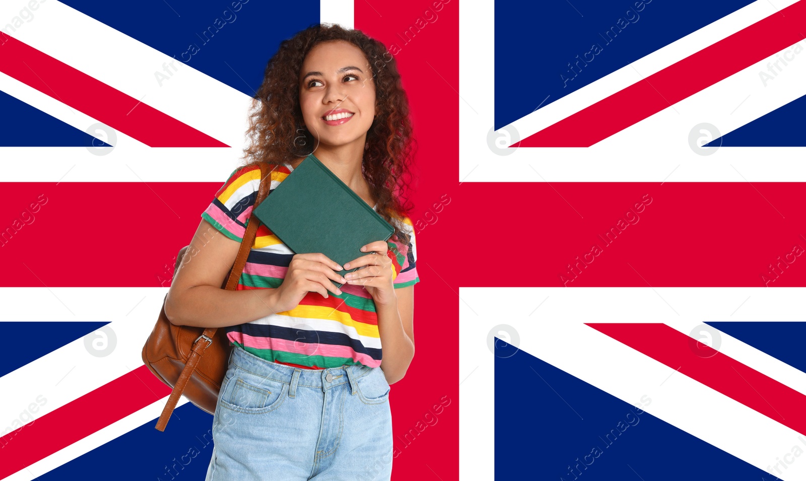 Image of Beautiful African-American girl with book and flag of Great Britain as background. Learning English