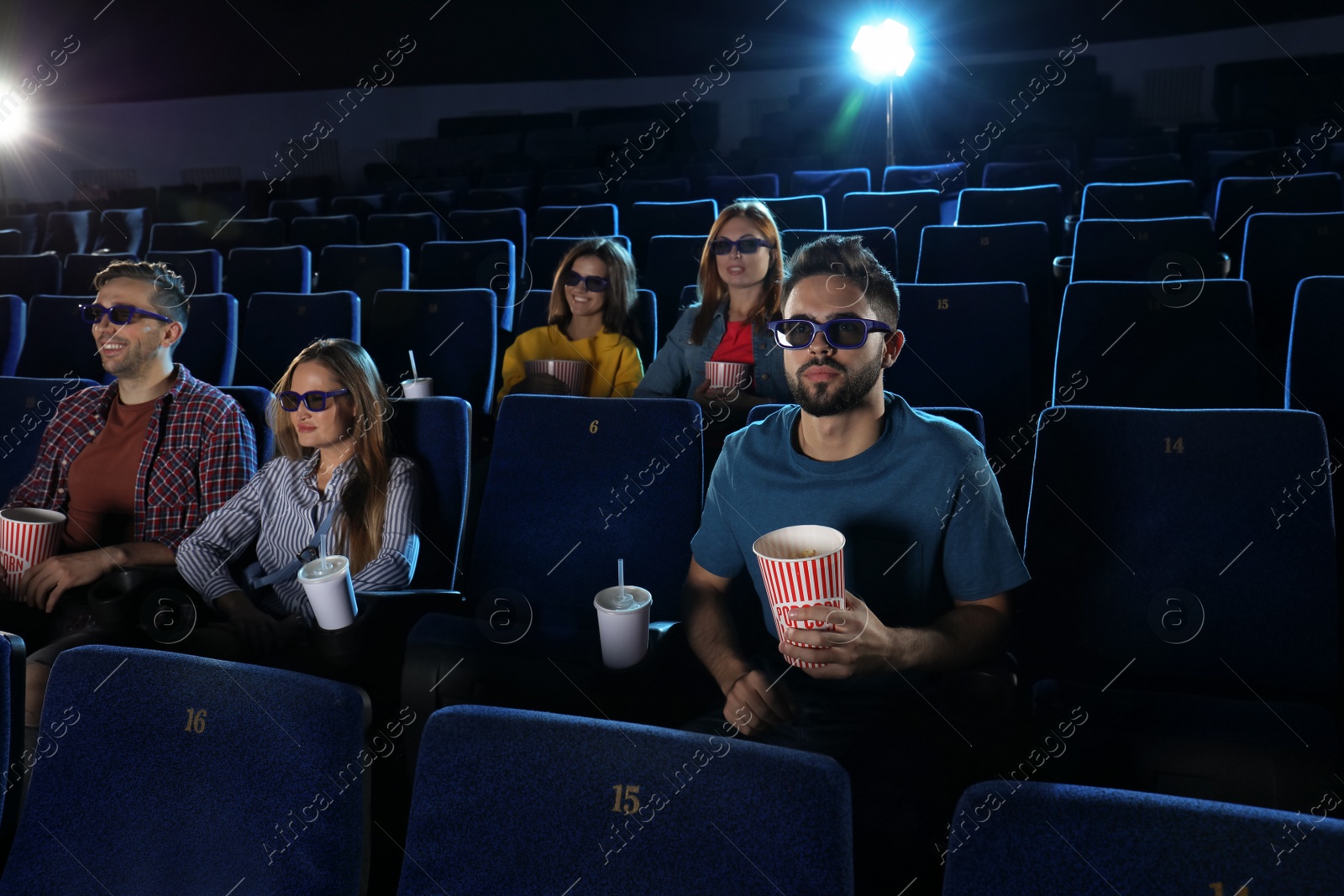 Photo of Young people watching movie in cinema theatre