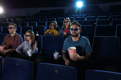 Photo of Young people watching movie in cinema theatre