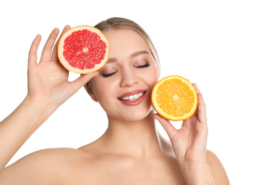 Young woman with cut orange and grapefruit on white background. Vitamin rich food