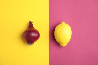 Photo of Beautiful composition with ripe red onion and lemon on color background