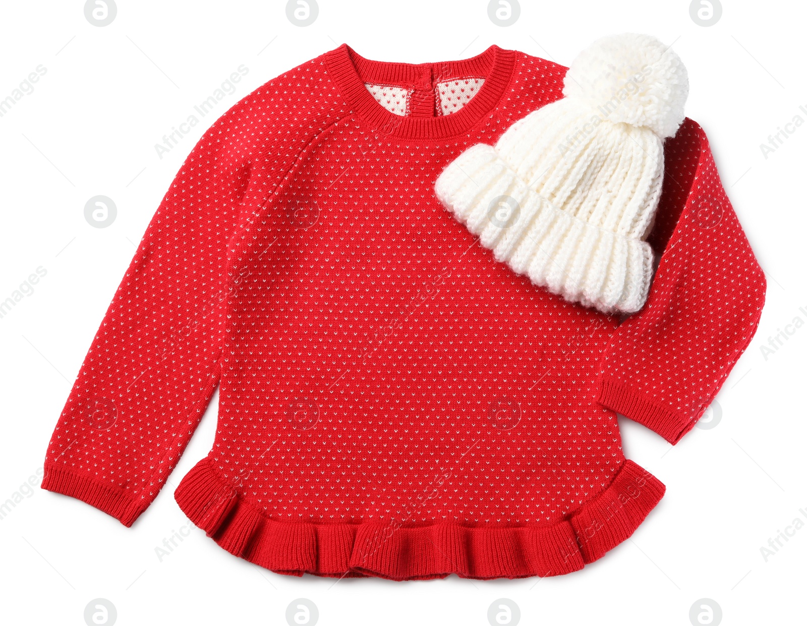 Photo of Red dress and knitted hat on white background, top view. Christmas baby clothes