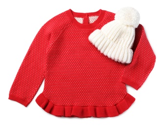 Red dress and knitted hat on white background, top view. Christmas baby clothes