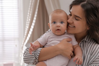 Photo of Happy young mother with her cute baby at home