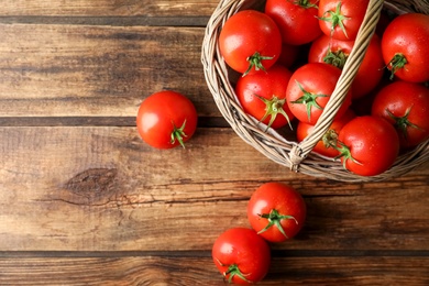 Fresh ripe tomatoes on wooden table, flat lay