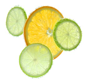 Slices of citrus fruits in sparkling water on white background