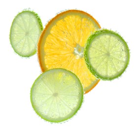 Photo of Slices of citrus fruits in sparkling water on white background