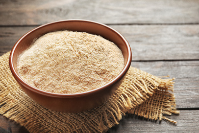 Image of Buckwheat flour in bowl on wooden table 