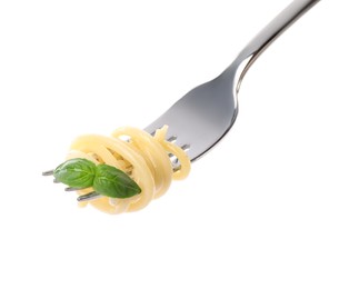 Fork with tasty pasta and basil isolated on white