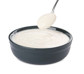 Bowl and spoon with delicious organic yogurt on white background