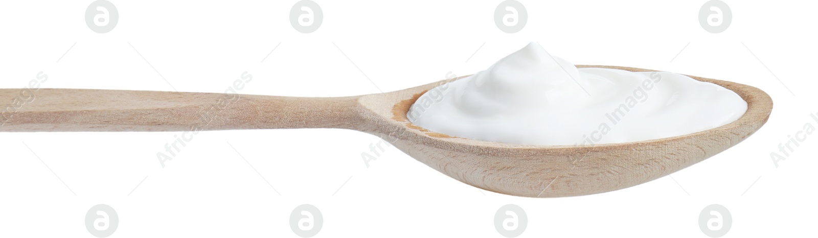 Photo of One wooden spoon with sour cream isolated on white