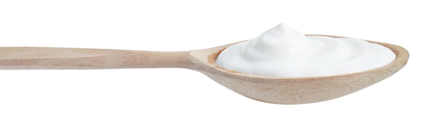 Photo of One wooden spoon with sour cream isolated on white