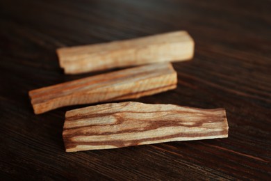 Palo santo sticks on wooden table, closeup