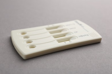 Photo of Disposable multi-infection express test on light grey background, closeup