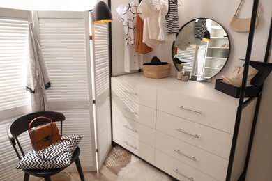 Photo of Closet interior with storage rack for clothes and accessories