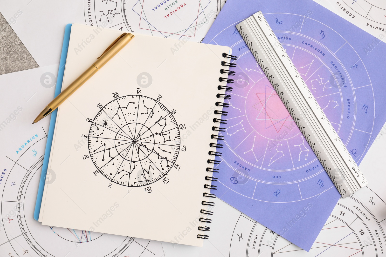 Photo of Natal charts for making forecast of fate and astrological items for fortune telling on table, flat lay