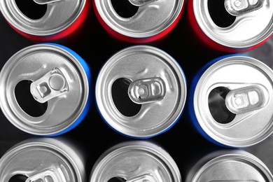 Photo of Energy drinks in cans as background, top view. Functional beverage