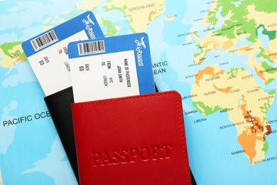 Honeymoon concept. Plane tickets and passports on world map, top view