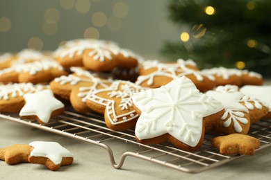 Tasty Christmas cookies with icing on table, closeup