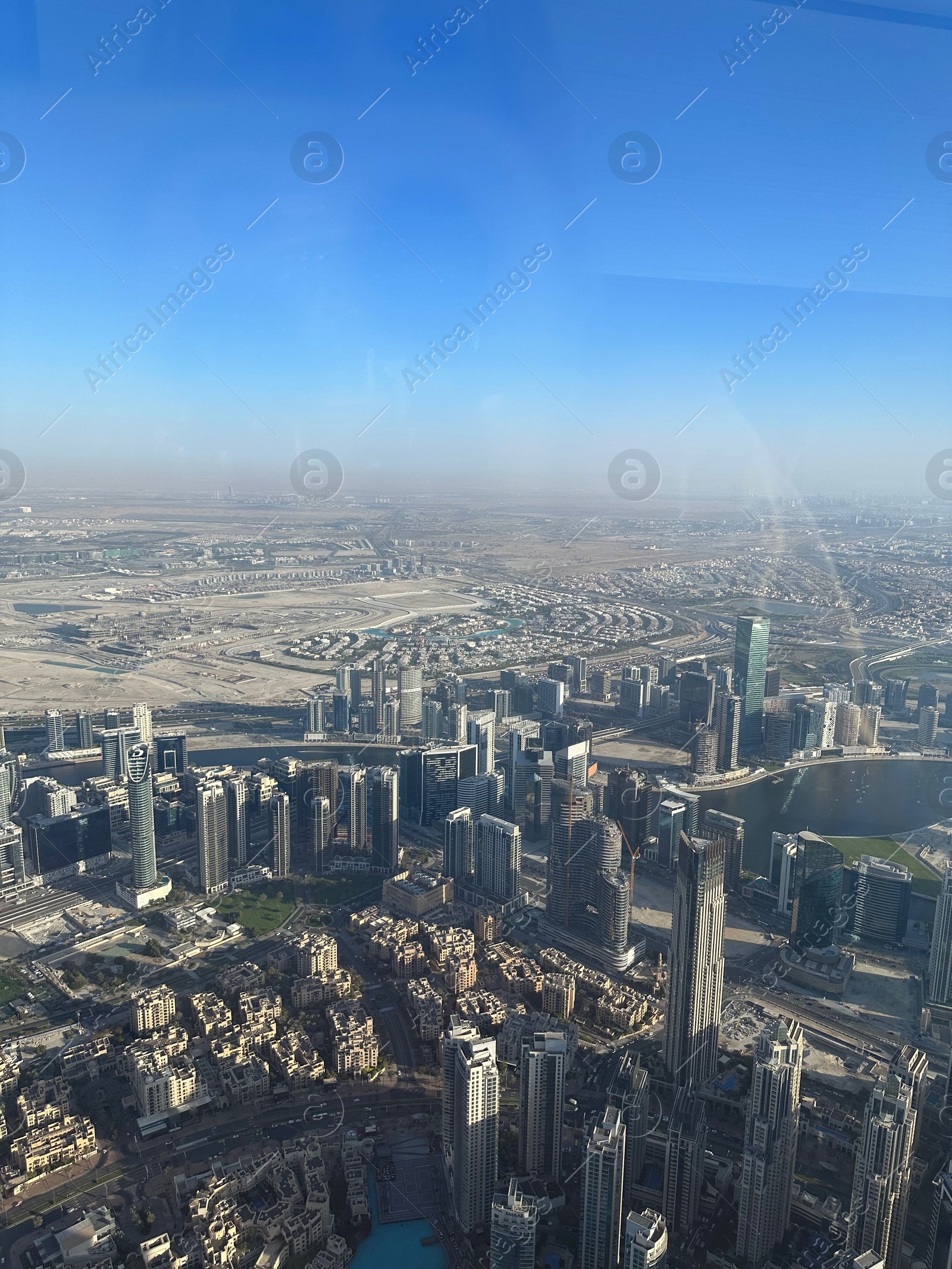 Photo of Dubai, United Arab Emirates - May 2, 2023: Picturesque view of city with skyscrapers from Burj Khalifa