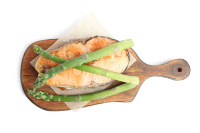 Tasty salmon steak with asparagus isolated on white, top view