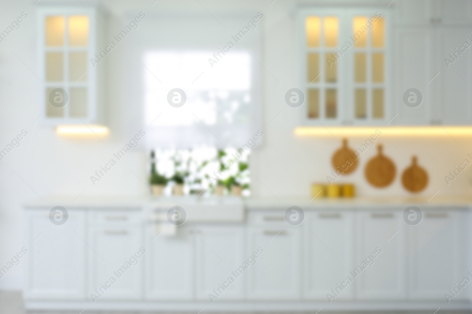 Photo of Blurred view of modern kitchen interior with stylish furniture