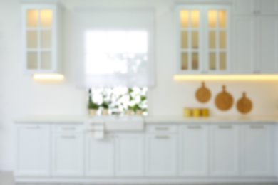 Photo of Blurred view of modern kitchen interior with stylish furniture